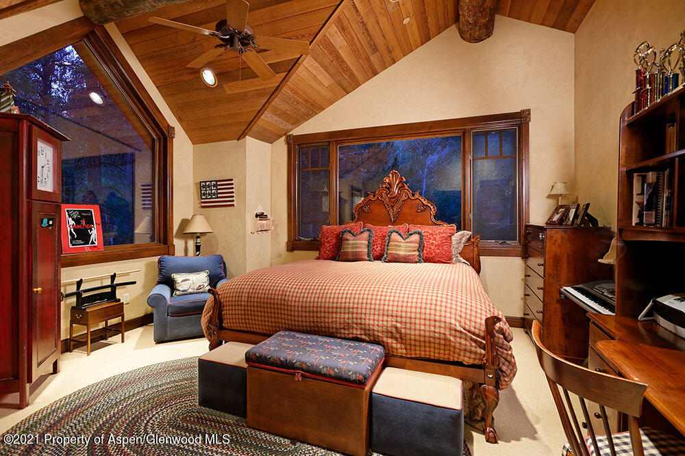 31 Northstar Circle Aspen, CO 81611 - Photo 31 of 51 a bedroom with a bed a couch and bookshelf