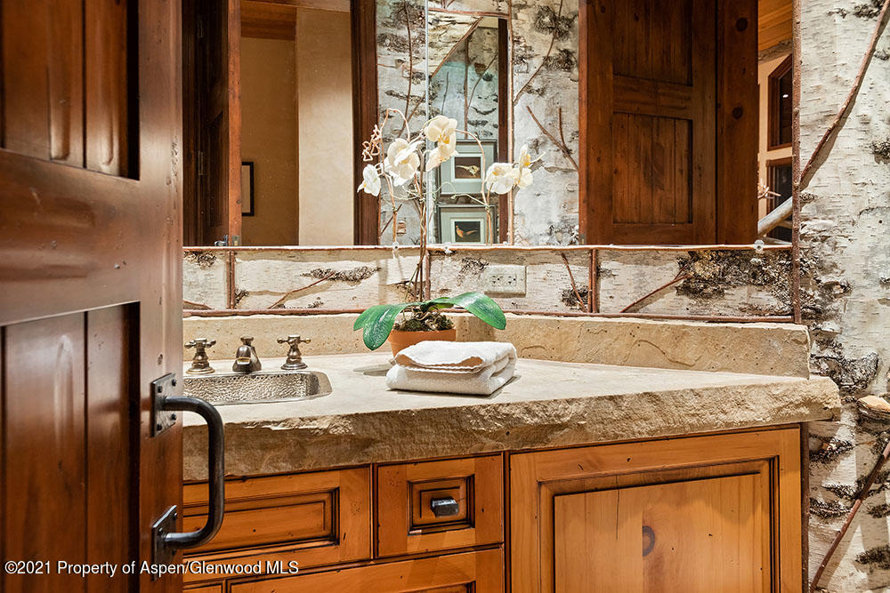 31 Northstar Circle Aspen, CO 81611 - Photo 38 of 51 a bathroom with a granite countertop sink and a mirror