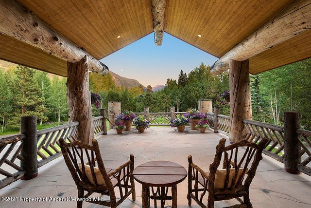 a view of a patio with table and chairs and potted plants