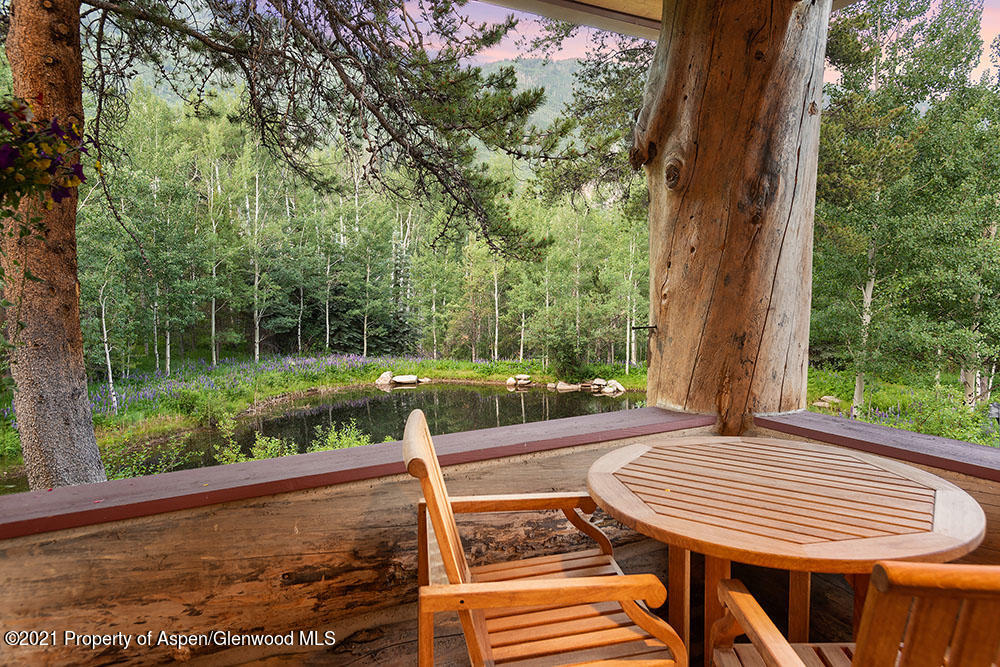31 Northstar Circle Aspen, CO 81611 - Photo 50 of 51 a view of a patio with table and chairs with wooden floor and fence
