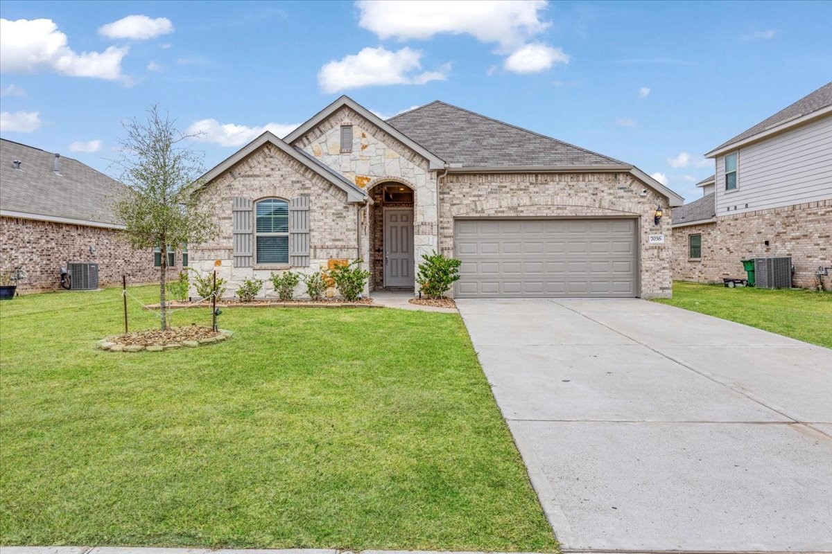 a front view of a house with a yard and garage