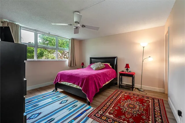 a view of a house with a big yard and palm trees