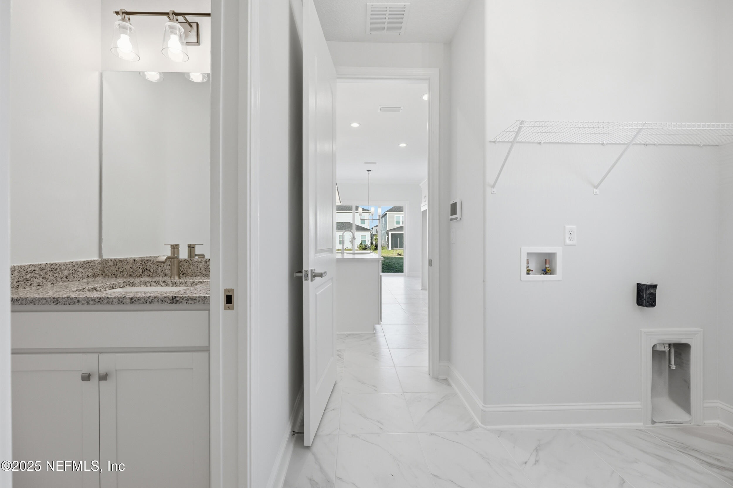 107 Firecrest Drive St. Augustine, FL 32092 - Photo 19 of 27 a bathroom with a granite countertop sink a mirror and shower