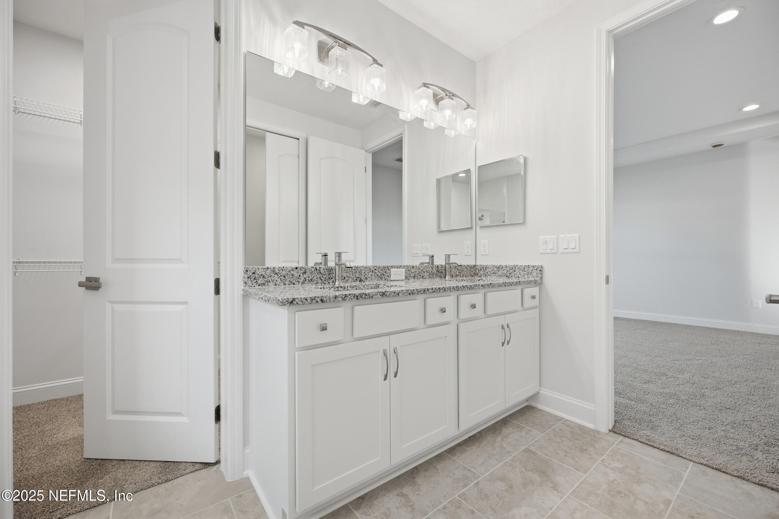 107 Firecrest Drive St. Augustine, FL 32092 - Photo 24 of 27 a bathroom with a granite countertop sink and a mirror