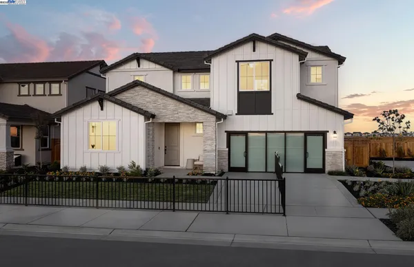 a front view of a house with a small garden