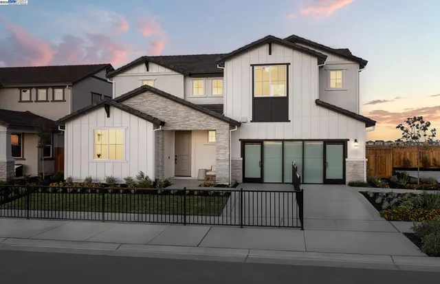 a front view of a house with a small garden