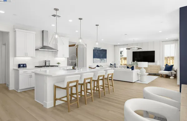 a living room with furniture a flat screen tv and kitchen view