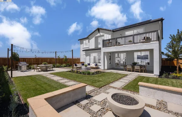 a view of a backyard with plants and a patio