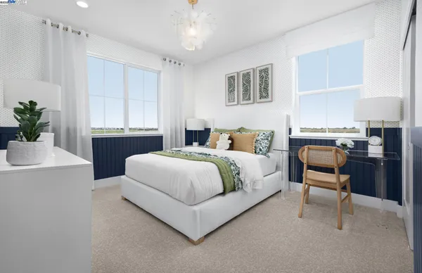 a bedroom with a large bed and a desk