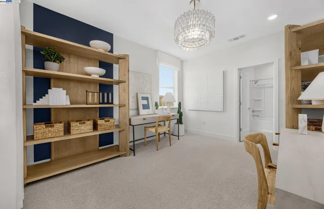 a view of a livingroom with furniture and staircase