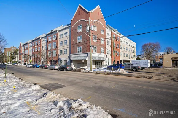 a view of a tall building next to a road