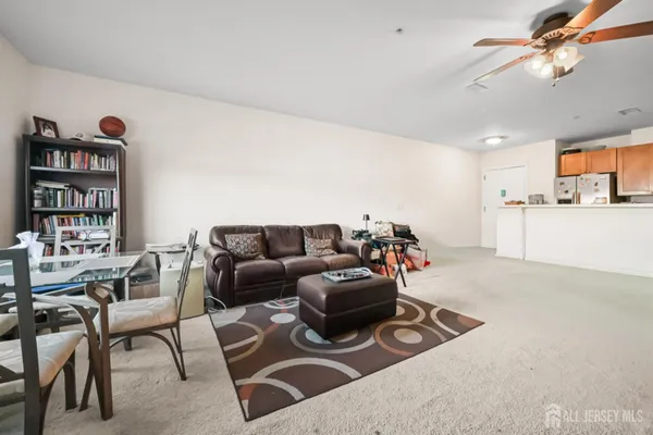 a living room with furniture a couch and bookshelf