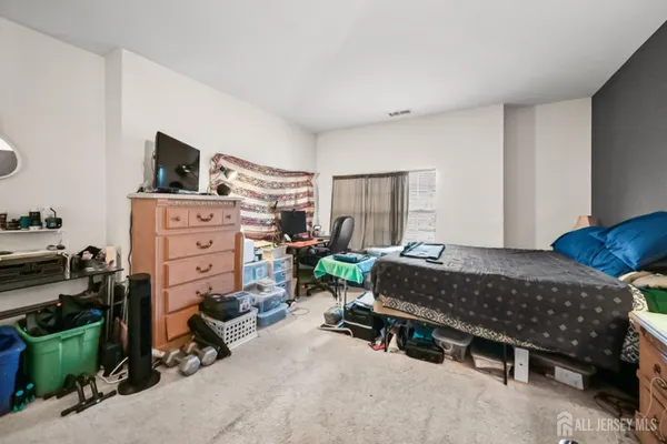 a bedroom with furniture and a flat tv screen