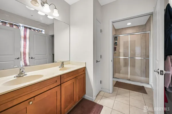a bathroom with a double vanity sink and mirror