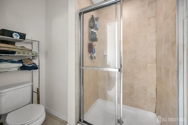 a bathroom with a shower toilet and sink
