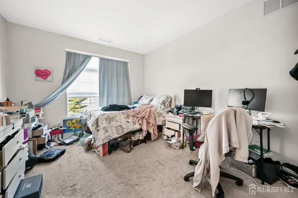 a bed room with a bed and a window