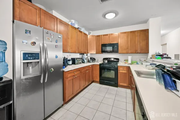 a kitchen with stainless steel appliances granite countertop a stove a sink dishwasher a refrigerator and a oven
