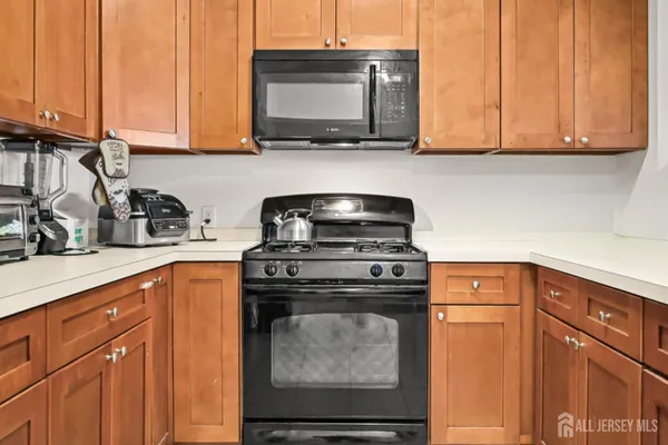 a kitchen with stainless steel appliances granite countertop a stove a microwave and cabinets