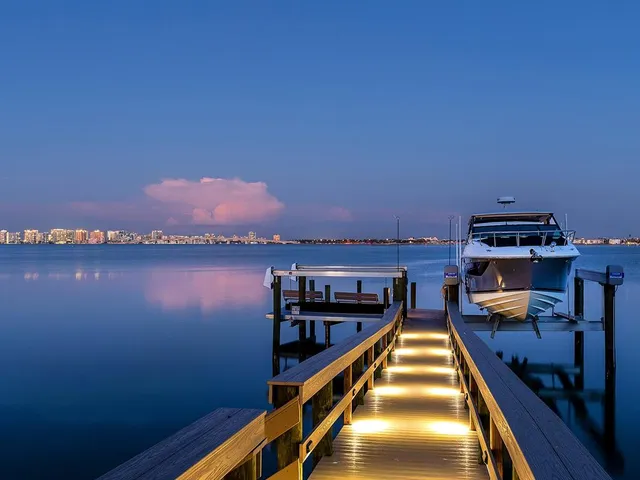 a view of a lake with a house swimming pool and outdoor space