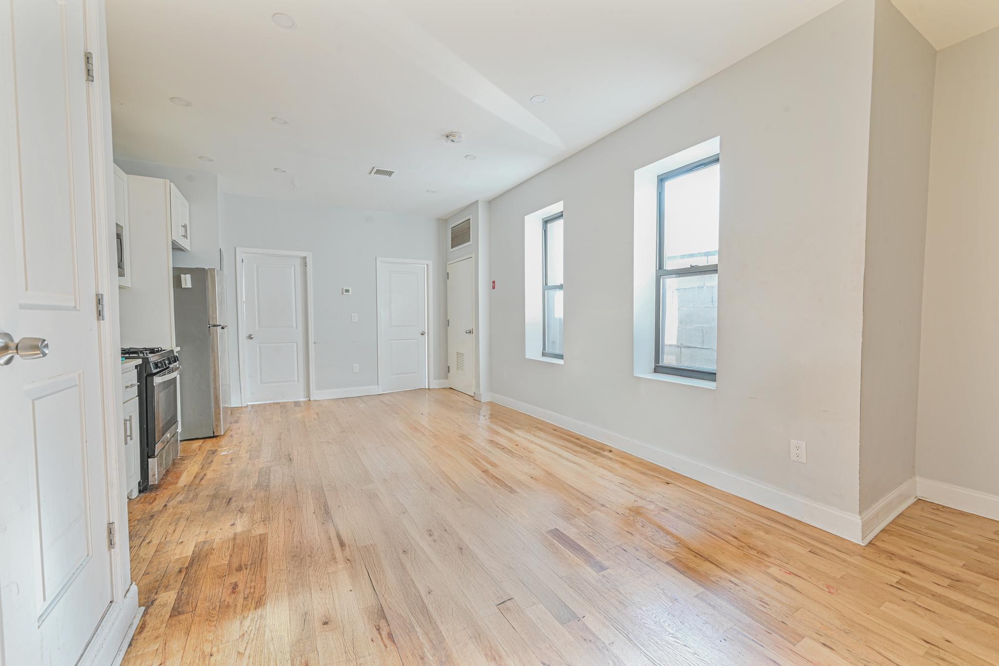 2243 Bathgate Avenue Bronx, NY 10457 - Photo 14 of 26 Unfurnished living room with light hardwood / wood-style floors