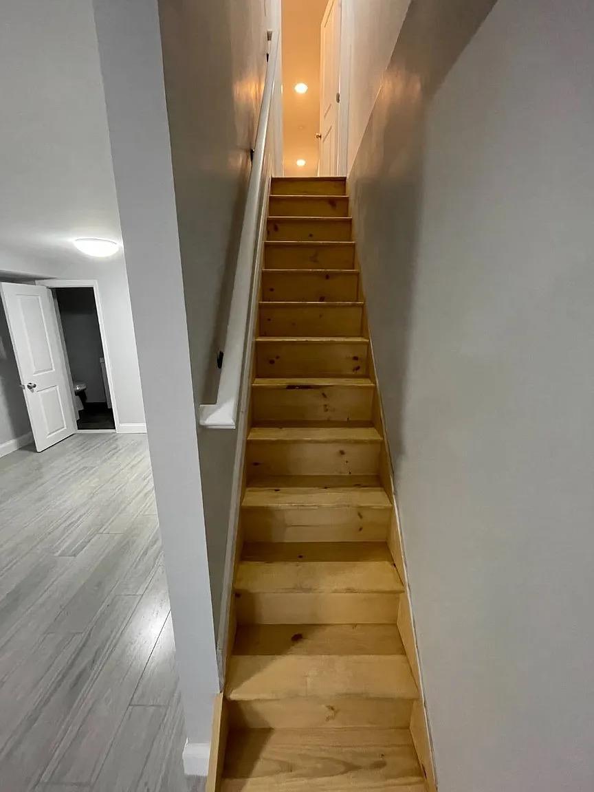 2243 Bathgate Avenue Bronx, NY 10457 - Photo 26 of 26 Staircase with hardwood / wood-style flooring