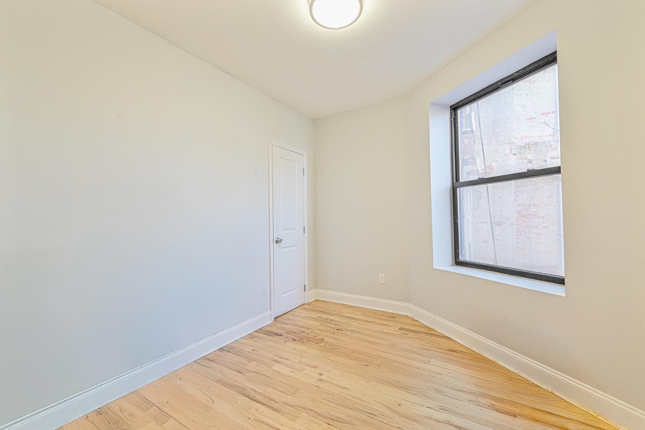 2243 Bathgate Avenue Bronx, NY 10457 - Photo 9 of 26 Spare room featuring light hardwood / wood-style flooring