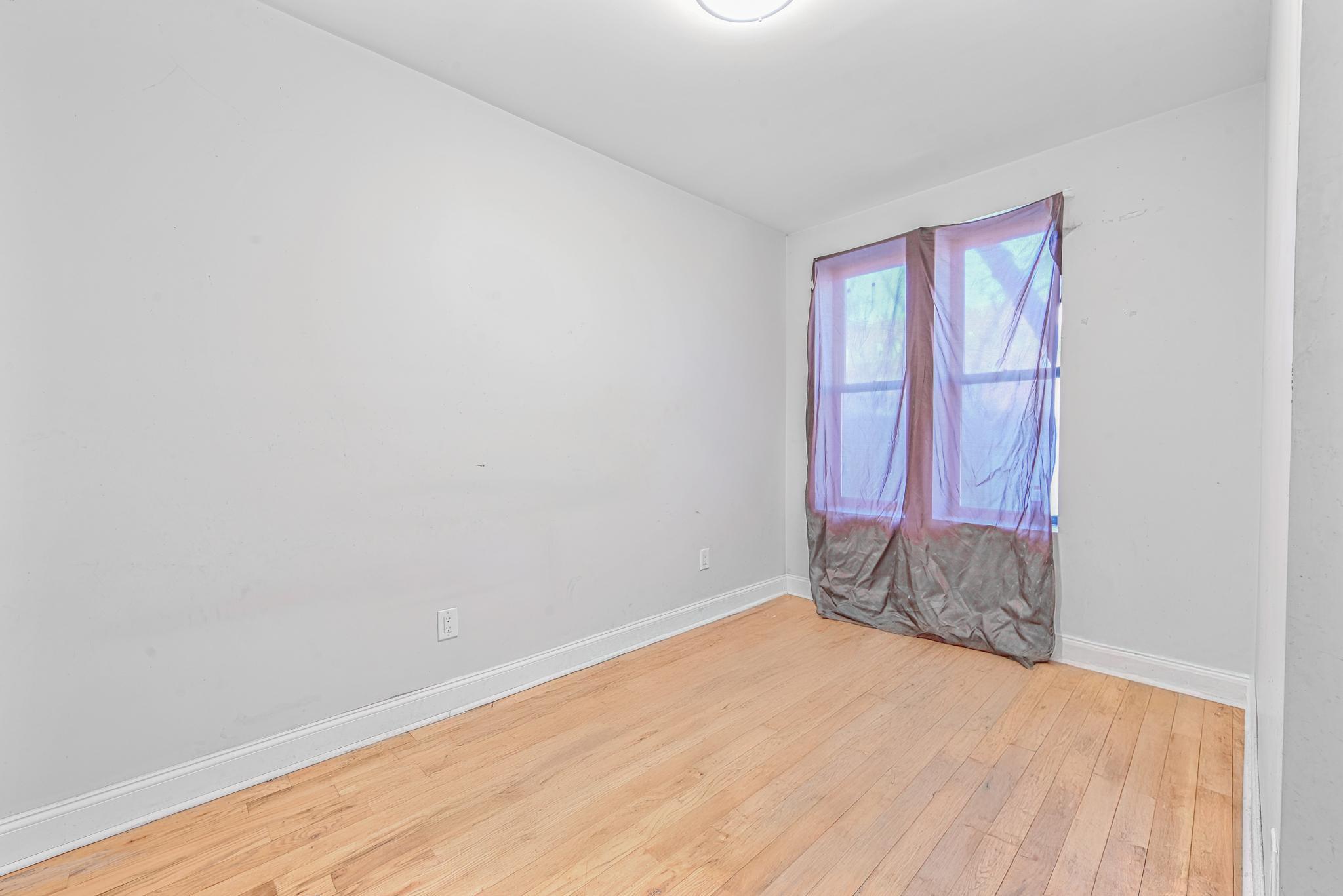 2243 Bathgate Avenue Bronx, NY 10457 - Photo 10 of 26 Spare room with light wood-type flooring