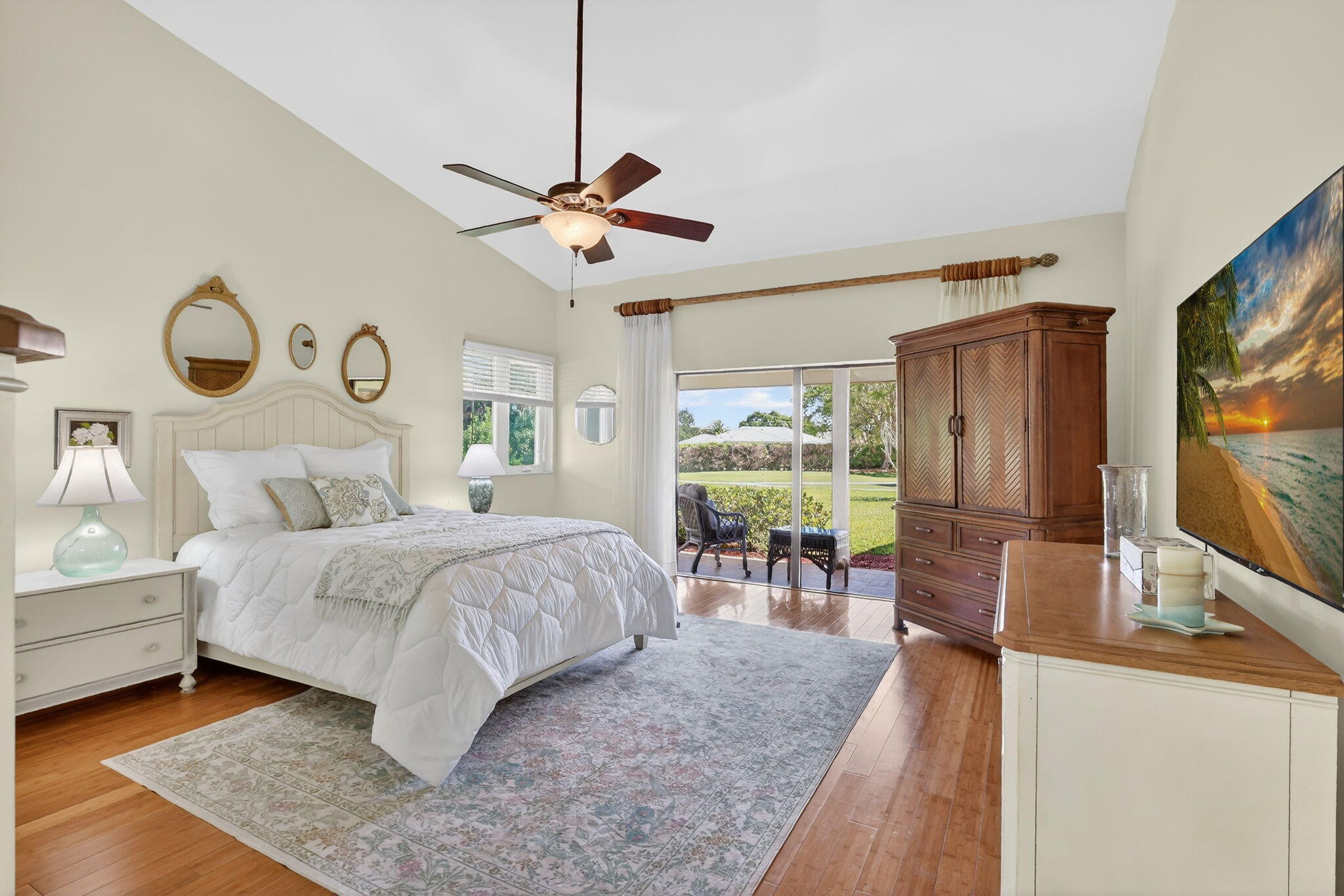 6151 Southeast Winged Foot Drive Stuart, FL 34997 - Photo 12 of 47 a spacious bedroom with a bed and a flat screen tv