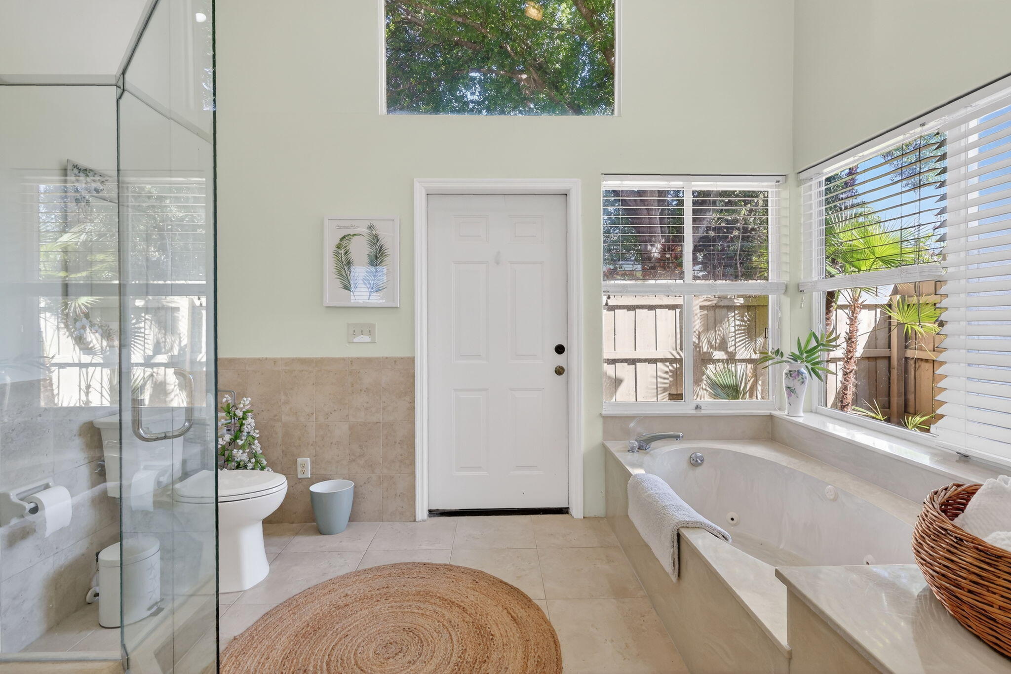 6151 Southeast Winged Foot Drive Stuart, FL 34997 - Photo 17 of 47 a bathroom with a granite countertop tub a sink and a large window
