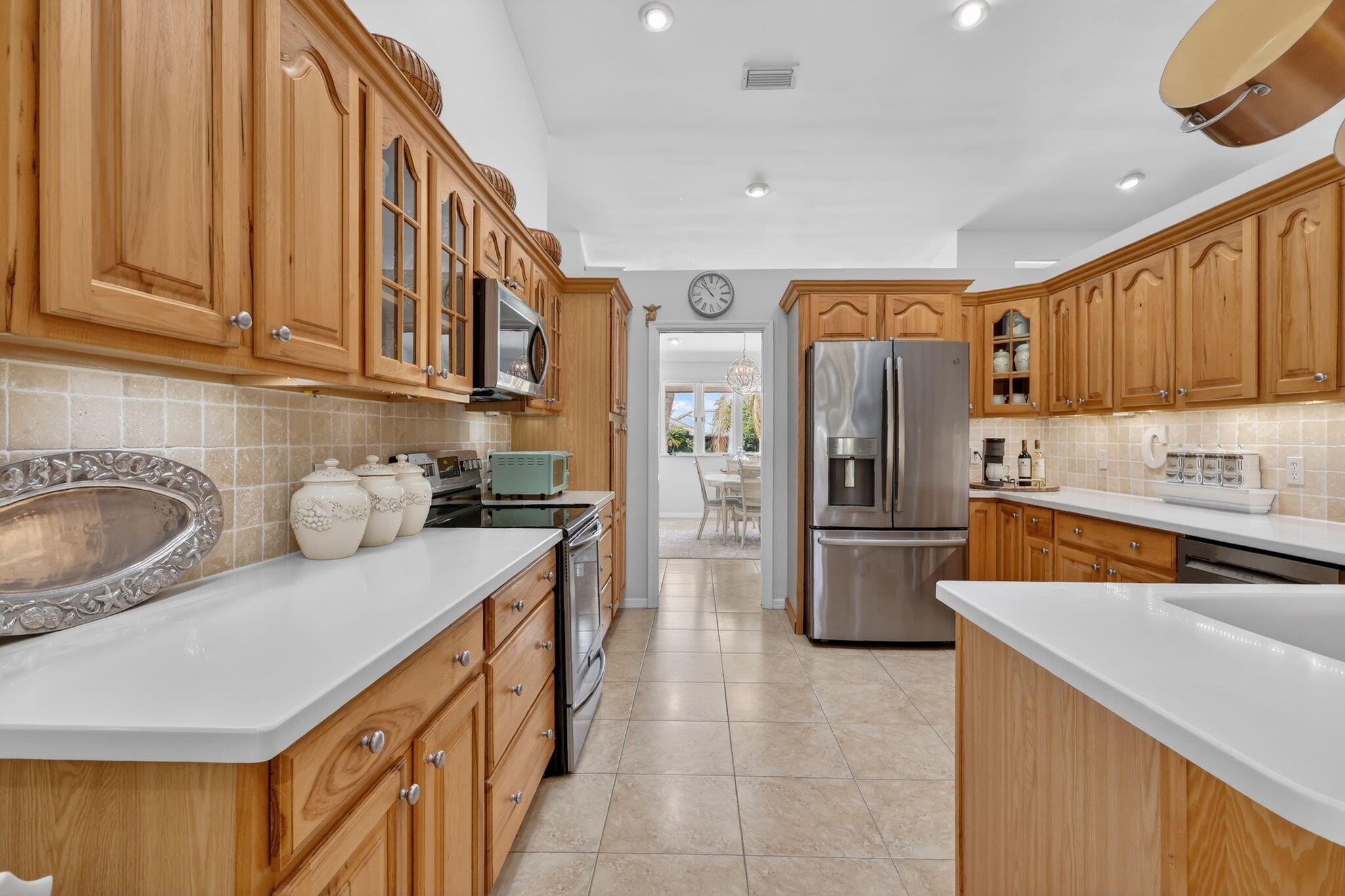 6151 Southeast Winged Foot Drive Stuart, FL 34997 - Photo 31 of 47 a kitchen with stainless steel appliances granite countertop a refrigerator a sink a stove and dishwasher