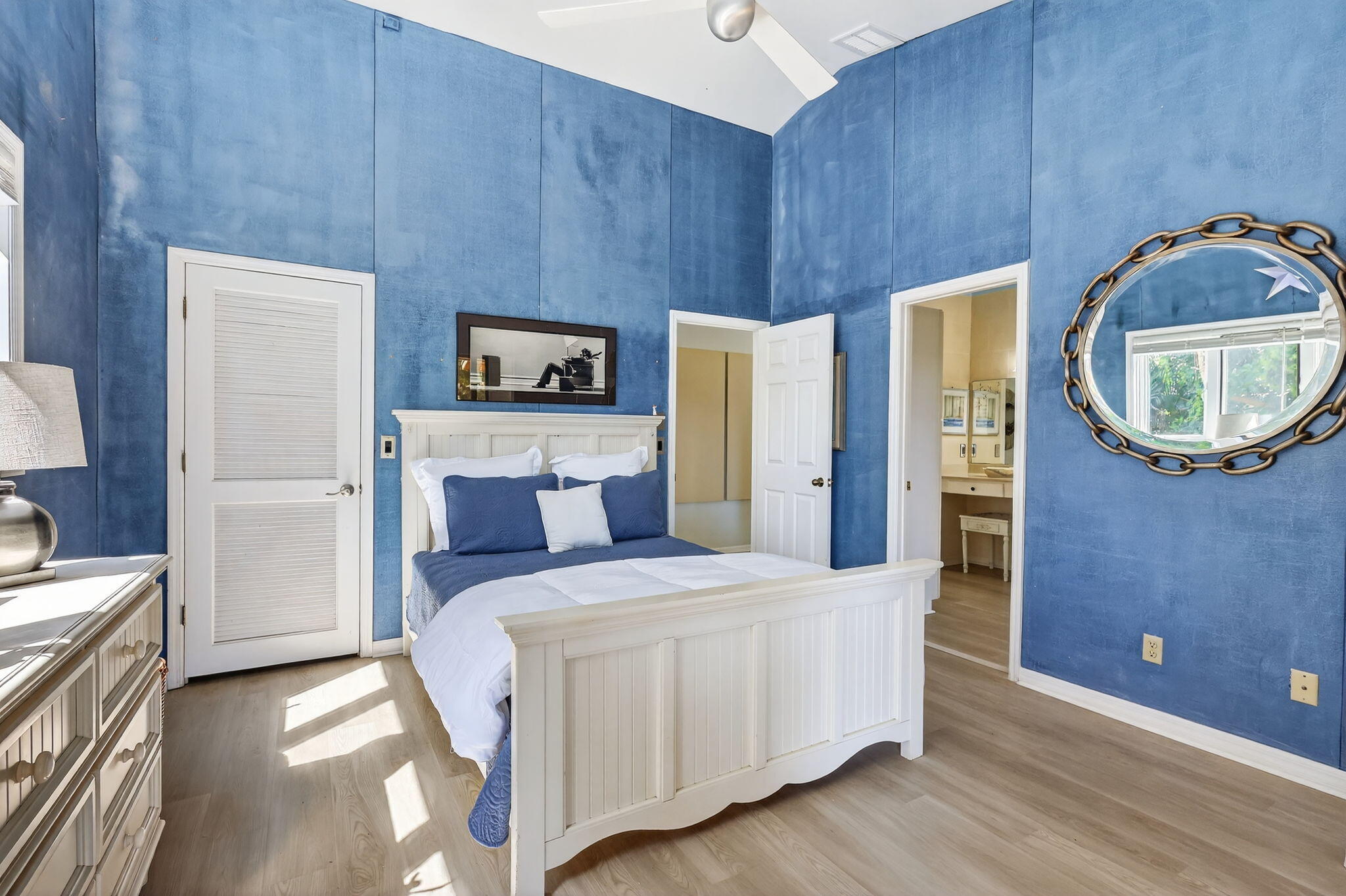 6151 Southeast Winged Foot Drive Stuart, FL 34997 - Photo 36 of 47 a room with a bed and a mirror