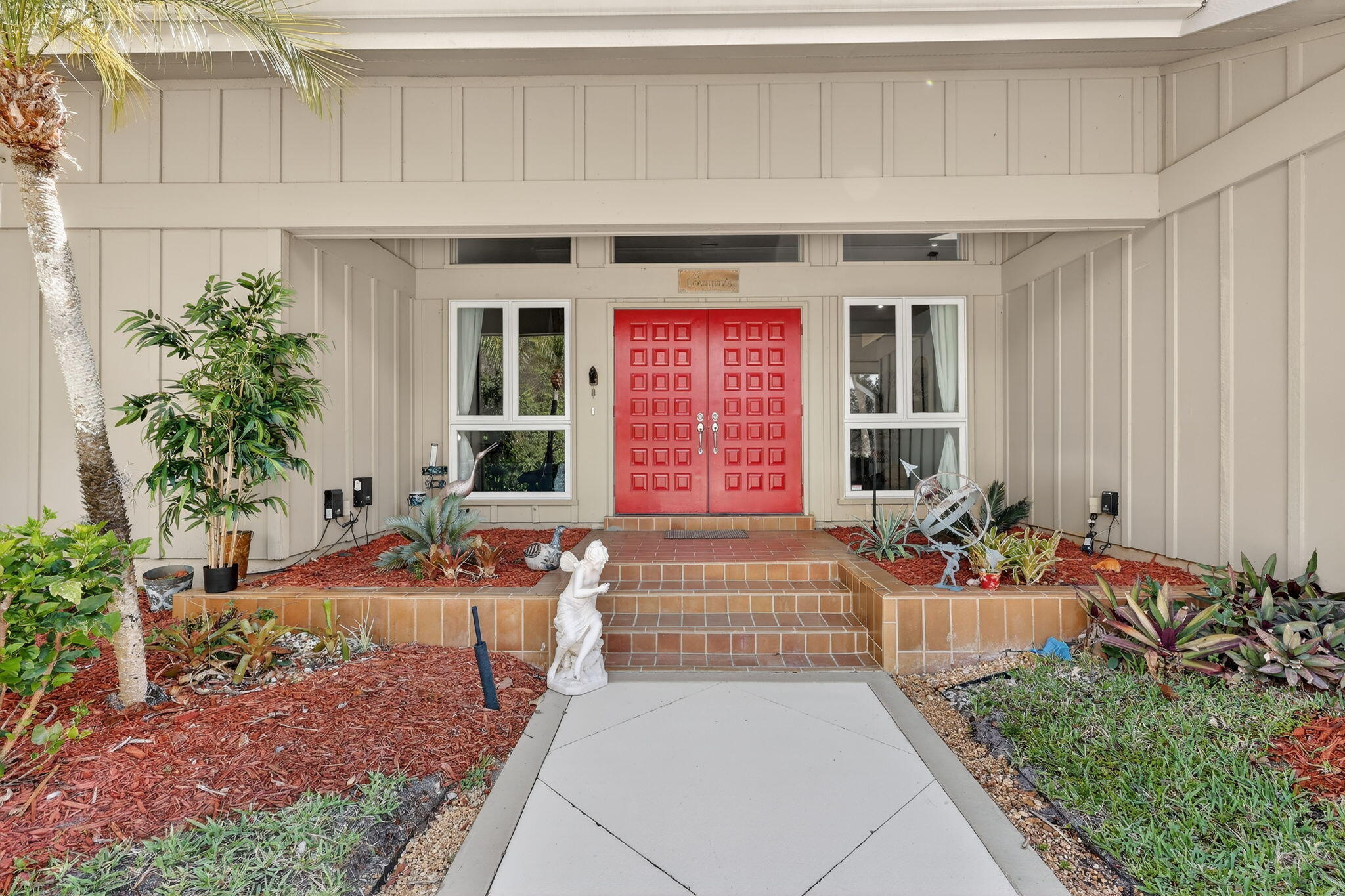 6151 Southeast Winged Foot Drive Stuart, FL 34997 - Photo 4 of 47 a front view of a house with outdoor seating
