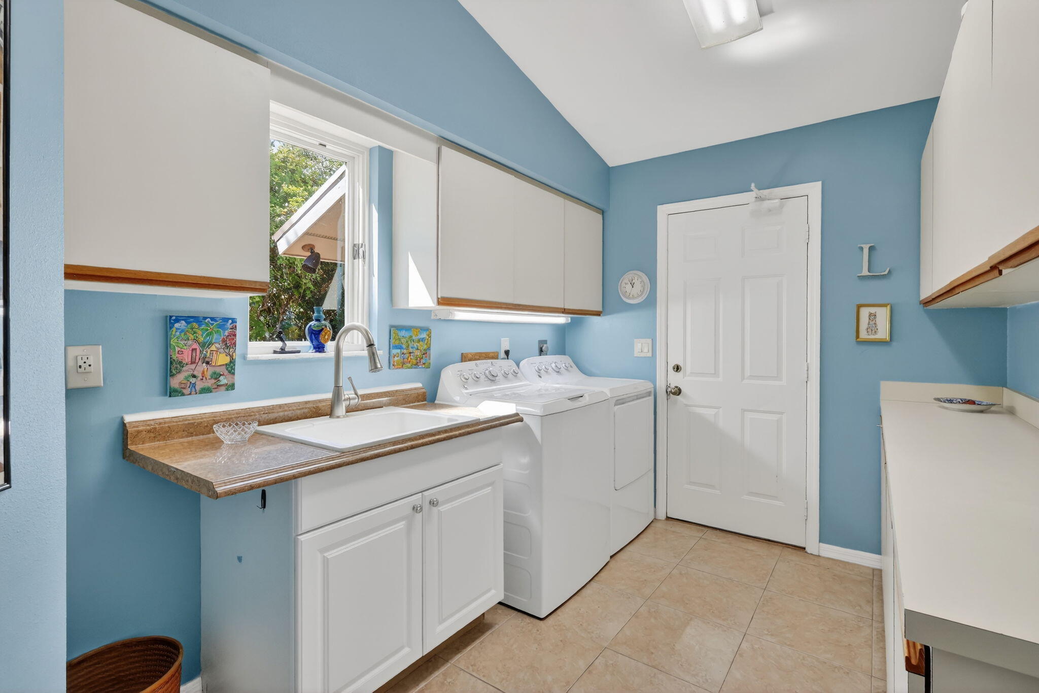 6151 Southeast Winged Foot Drive Stuart, FL 34997 - Photo 41 of 47 a kitchen with a sink and a refrigerator