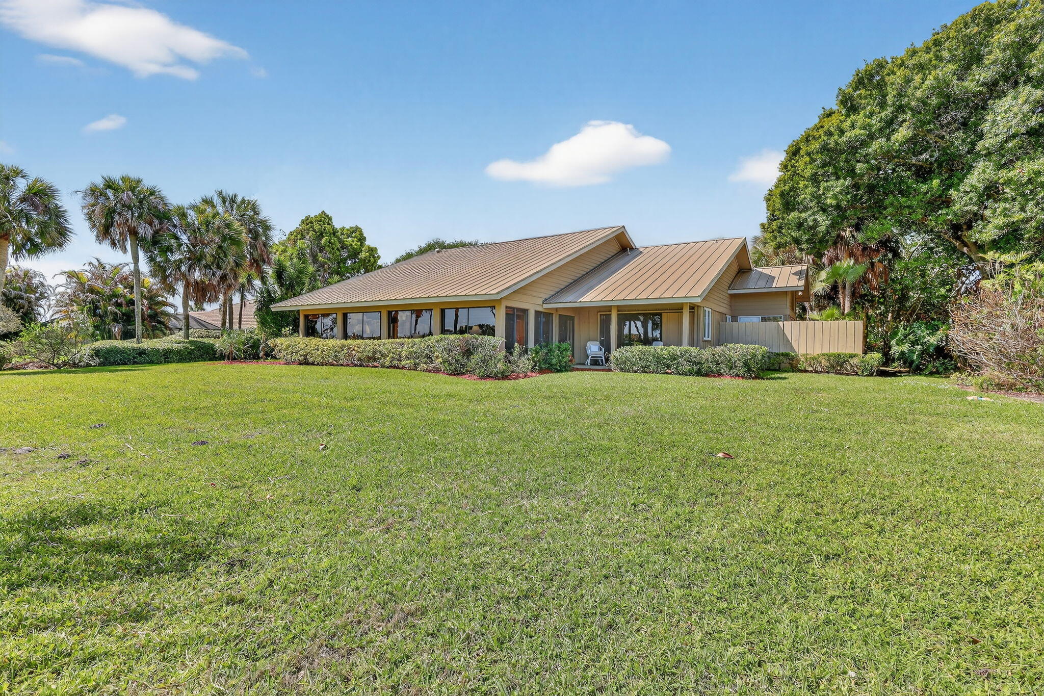 6151 Southeast Winged Foot Drive Stuart, FL 34997 - Photo 5 of 47 a front view of a house with garden