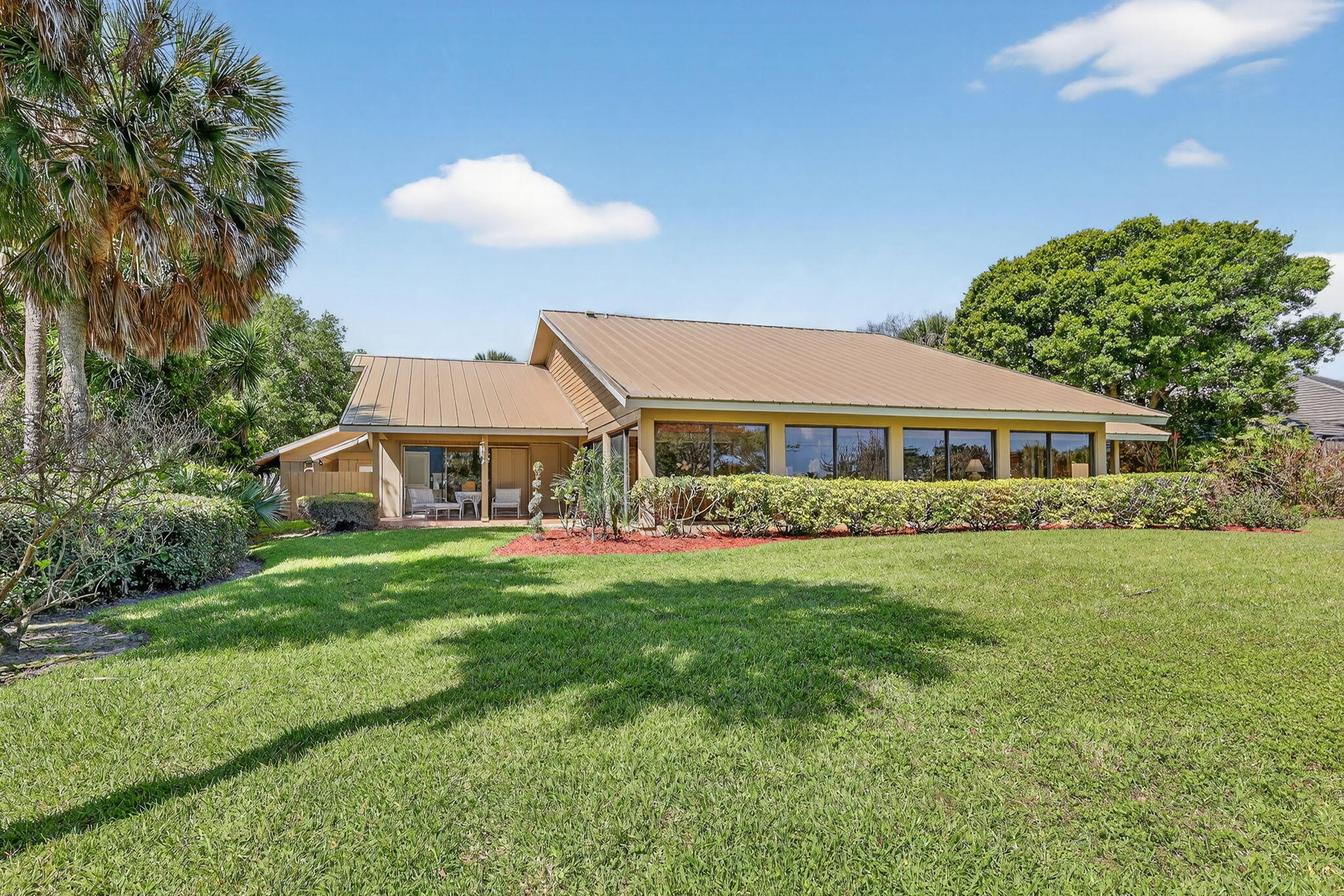6151 Southeast Winged Foot Drive Stuart, FL 34997 - Photo 6 of 47 a front view of a house with a garden