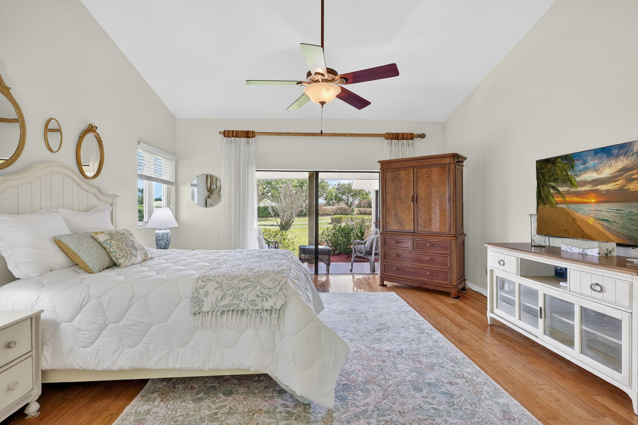 6151 Southeast Winged Foot Drive Stuart, FL 34997 - Photo 10 of 47 a bedroom with a bed and a flat screen tv