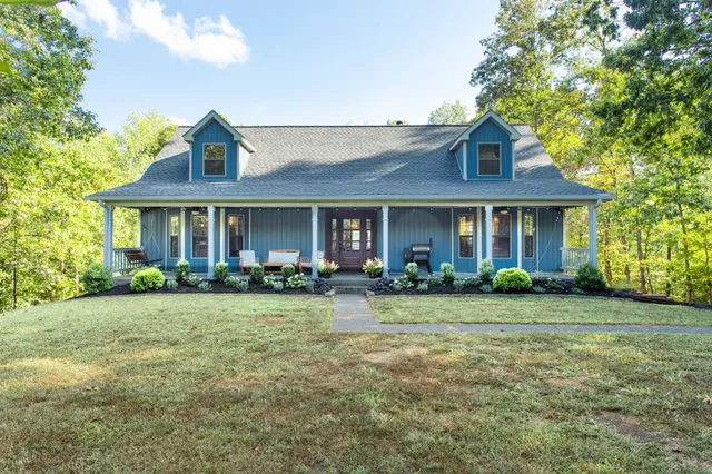 a front view of a house with swimming pool and porch