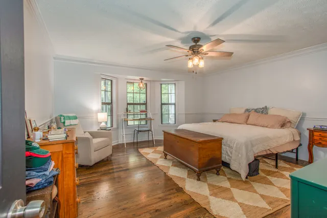 a bedroom with a bed and a chandelier