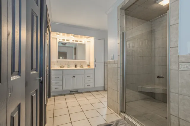 a bathroom with a granite countertop sink a toilet and shower