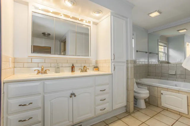 a bathroom with a granite countertop sink mirror and toilet
