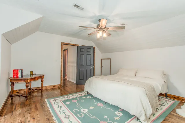 a bedroom with a bed and a chandelier