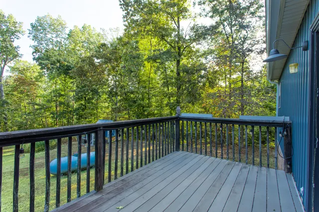 a view of a backyard with table and chairs and wooden fence
