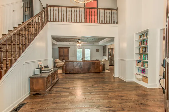 a view of entryway and hall with wooden floor