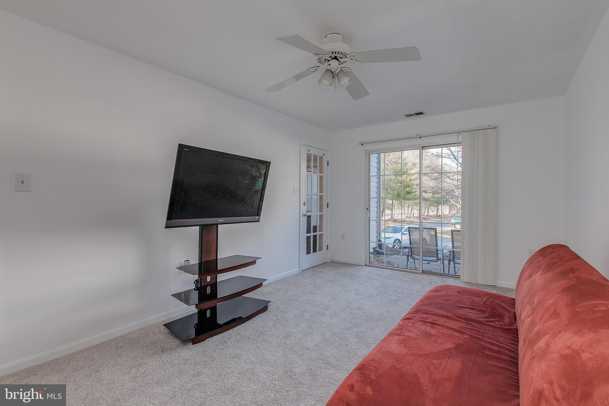 2611 Warren Way, Unit 41 Frederick, MD 21701 - Photo 9 of 35 Family Room w/ Ceiling Fan & Walk-out to Porch