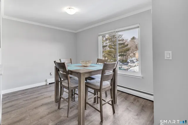 a dining room with furniture and window