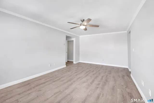 a view of empty room with wooden floor