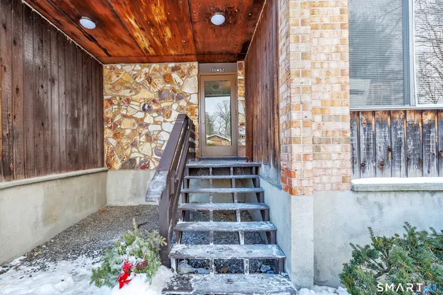 a view of staircase with wooden floor and a potted plant