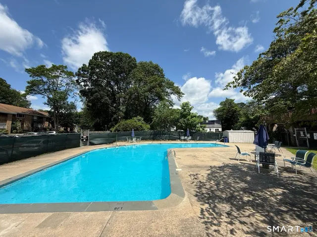 a view of a swimming pool with an outdoor space and seating area