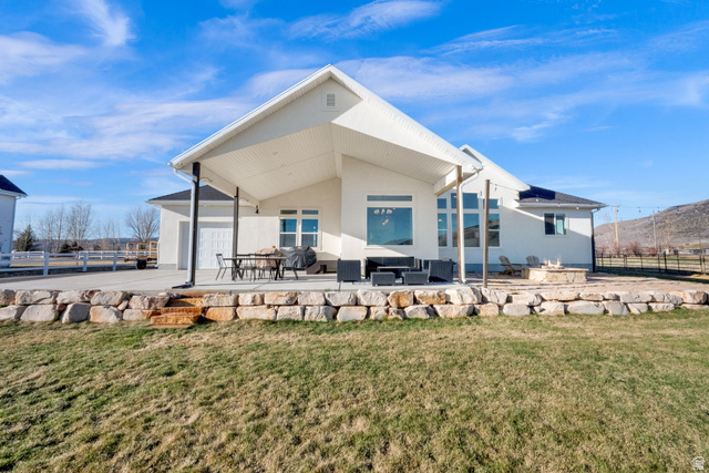 352 East Boulderville Road Oakley, UT 84055 - Photo 43 of 62 Back of property featuring a patio, stucco siding, an outdoor lounge area, and a garage