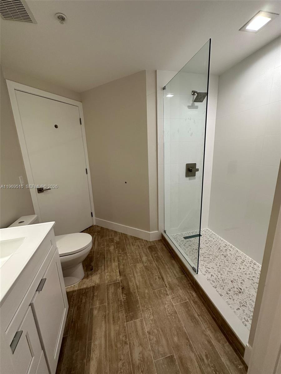 801 Brickell Key Boulevard, Unit 809 Miami, FL 33131 - Photo 17 of 17 a bathroom with a granite countertop sink toilet and shower